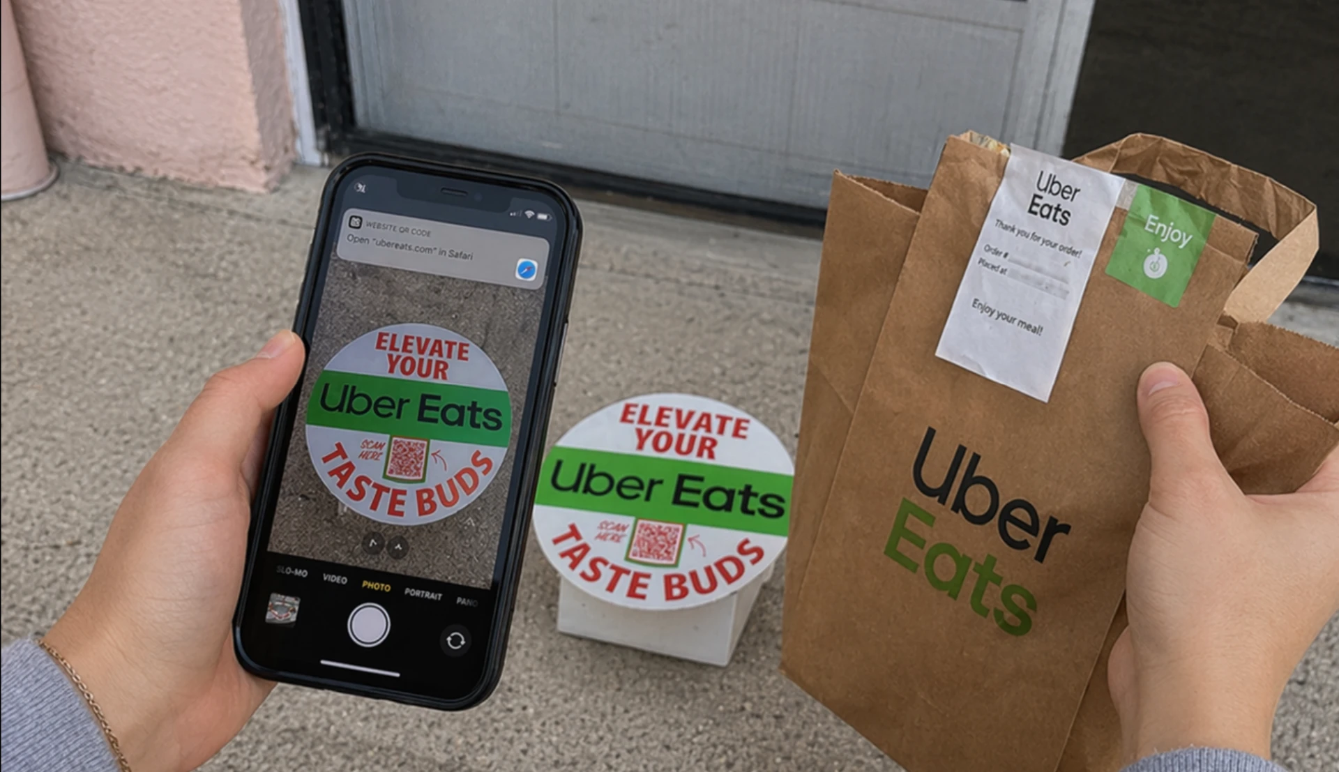 Customer picking up an Uber Eats delivery and scanning the Elevate Your Taste Buds QR code