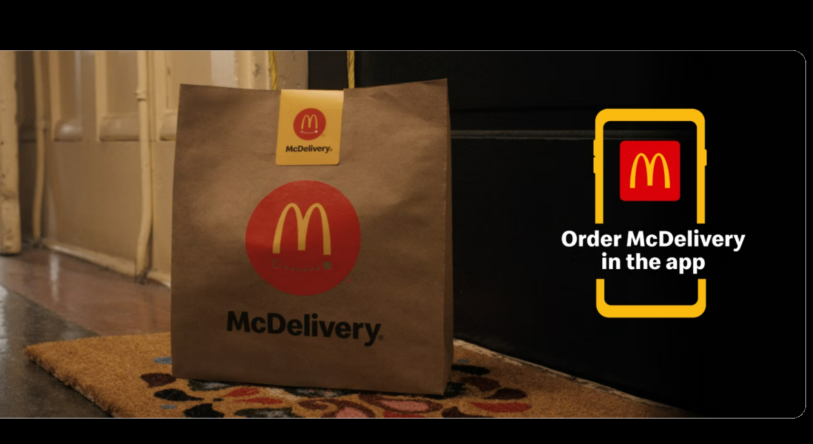 McDelivery bag sitting on the ground at a customer's doorstep — from McDonald's own marketing.